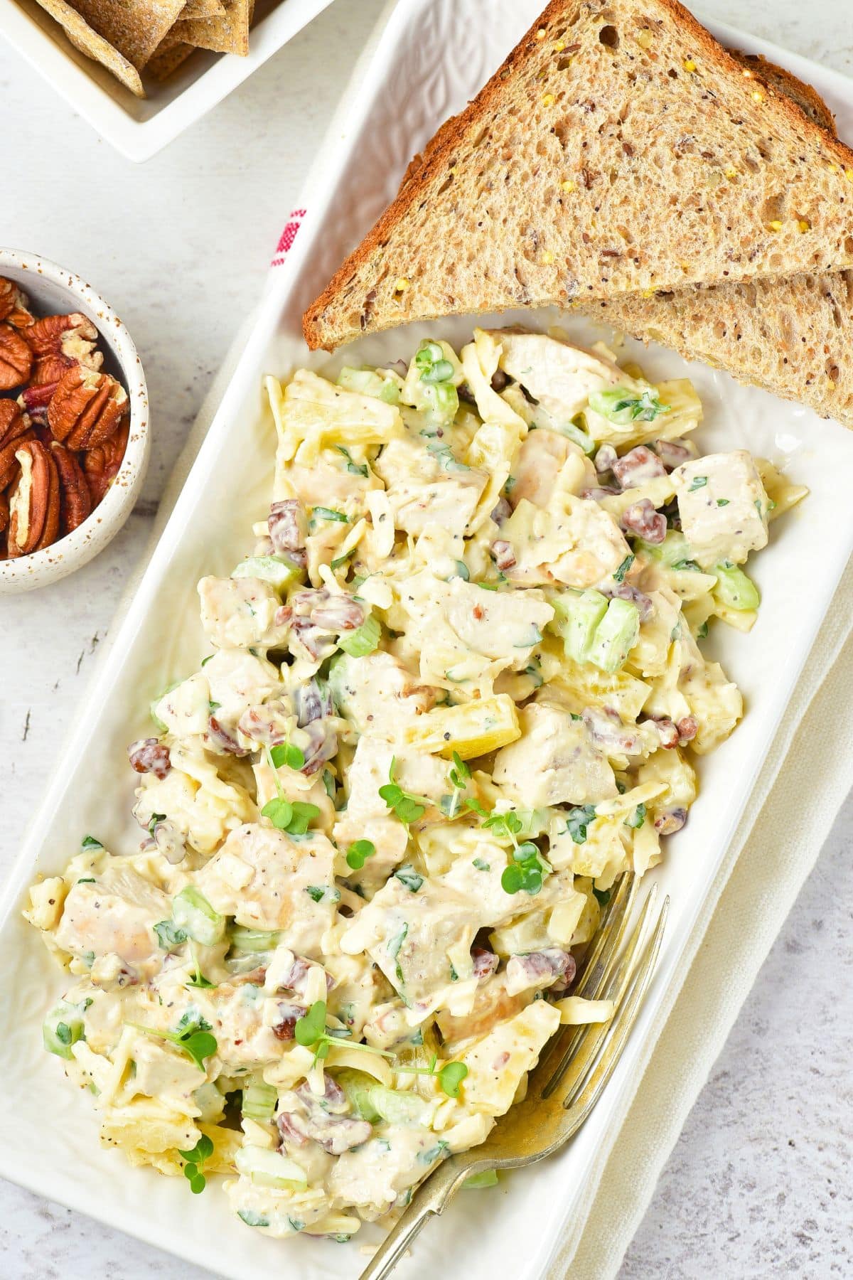 A plate of chicken and pineapple salad with slices of bread