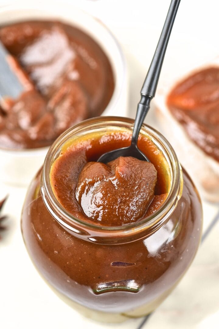 Holding up a spoonful of pumpkin apple butter
