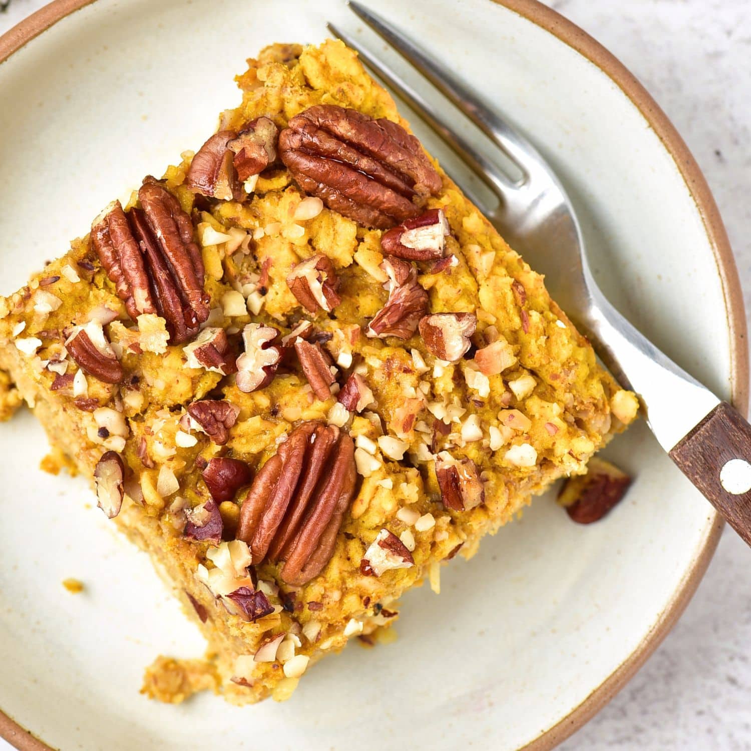 Top down view of a slice of pumpkin baked oatmeal on a plate