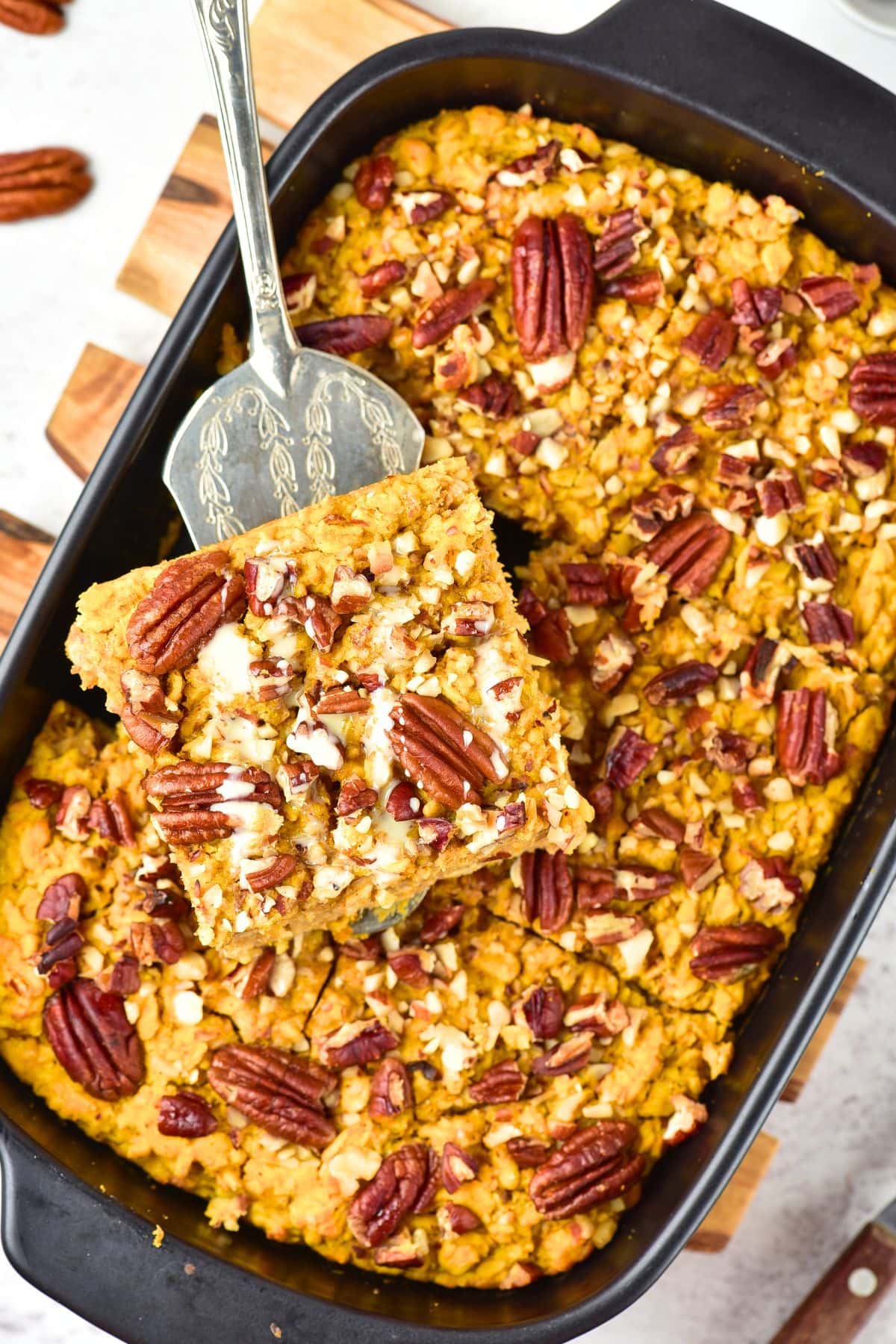 Using a spatula to hold up a portion of pumpkin oatmeal bake