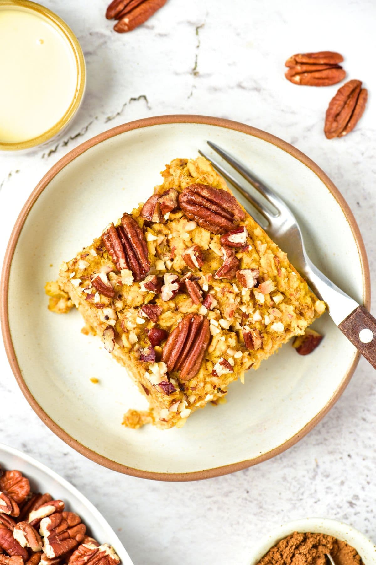 Top down view of a fork on a plate of pumpkin baked oatmeal