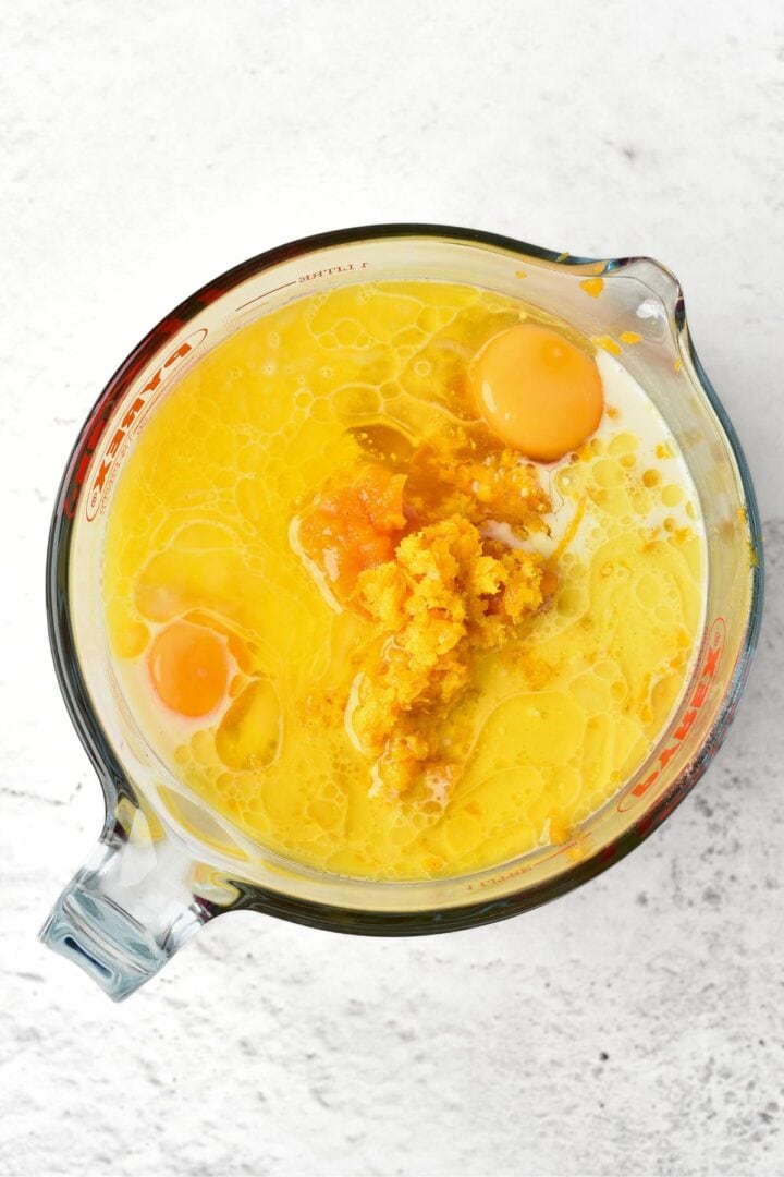 Pumpkin puree, milk, eggs, melted butter in measuring bowl.