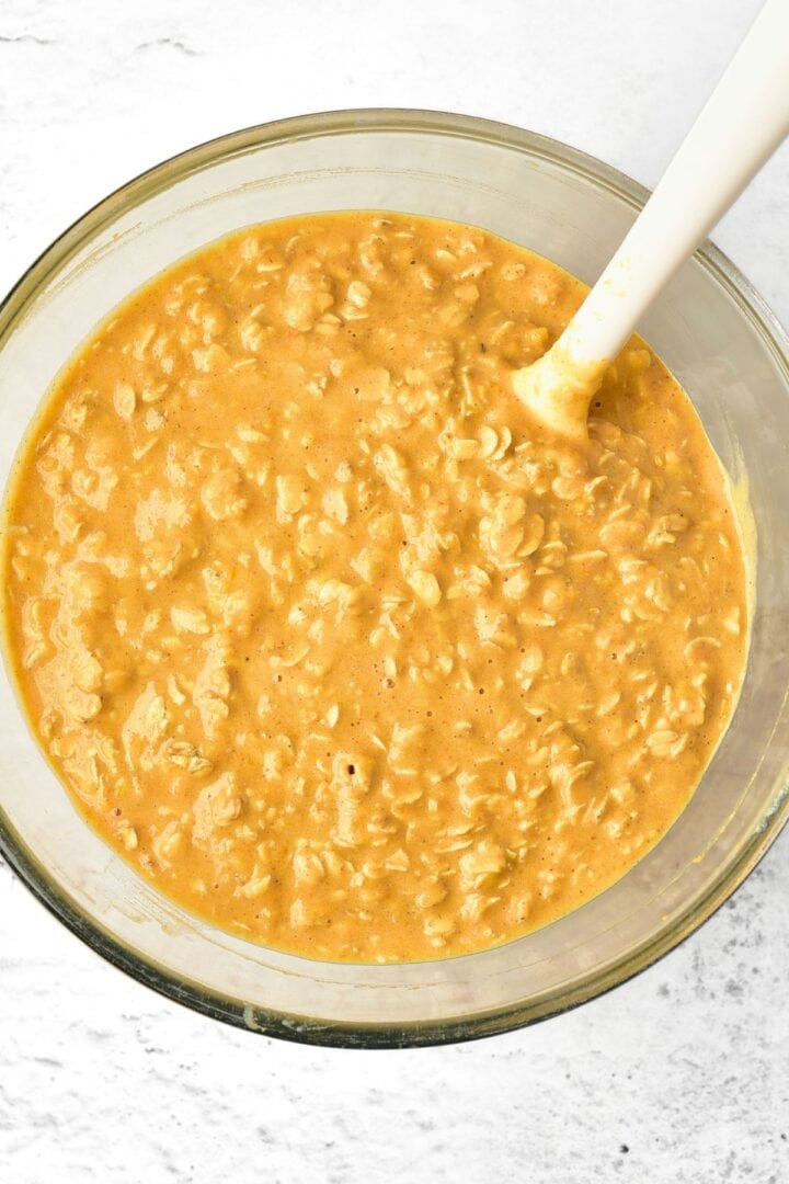 Pumpkin oatmeal mixture in glass bowl.