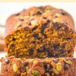 Half-sliced loaf of chocolate chip pumpkin bread.