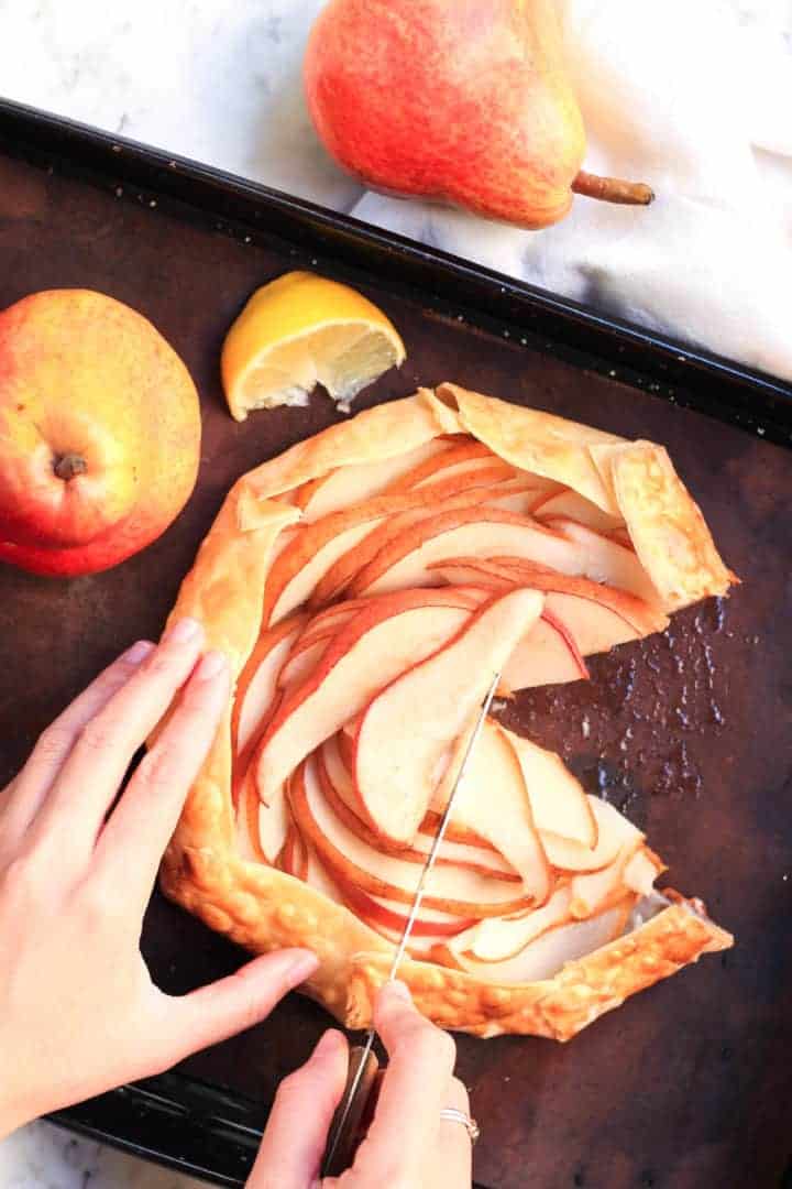 Slicing into pear galette.