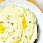 Top down view of a large bowl of garlic mashed potatoes