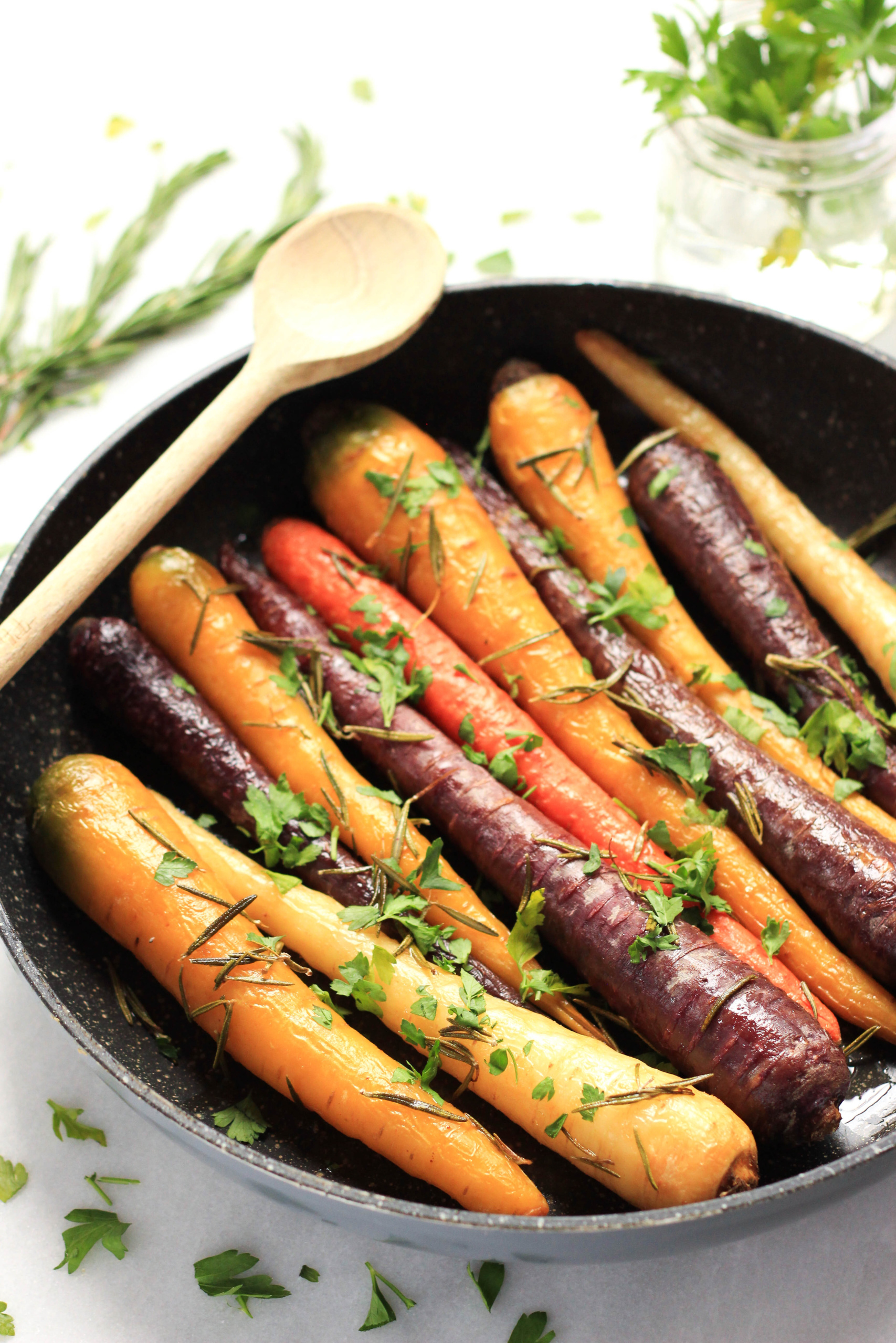 A skillet filled with roasted rainbow carrots.