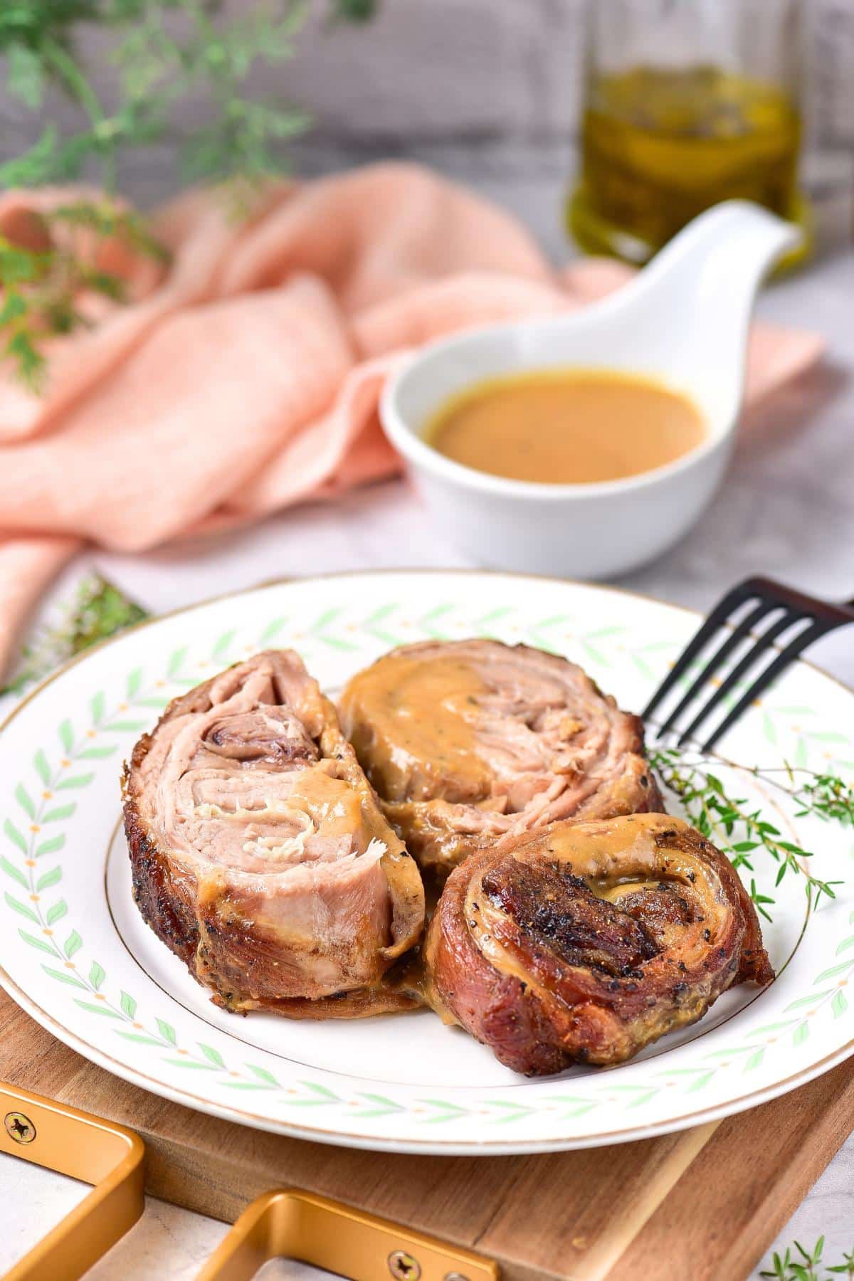 A plate of slow roasted lamb slices served with gravy.