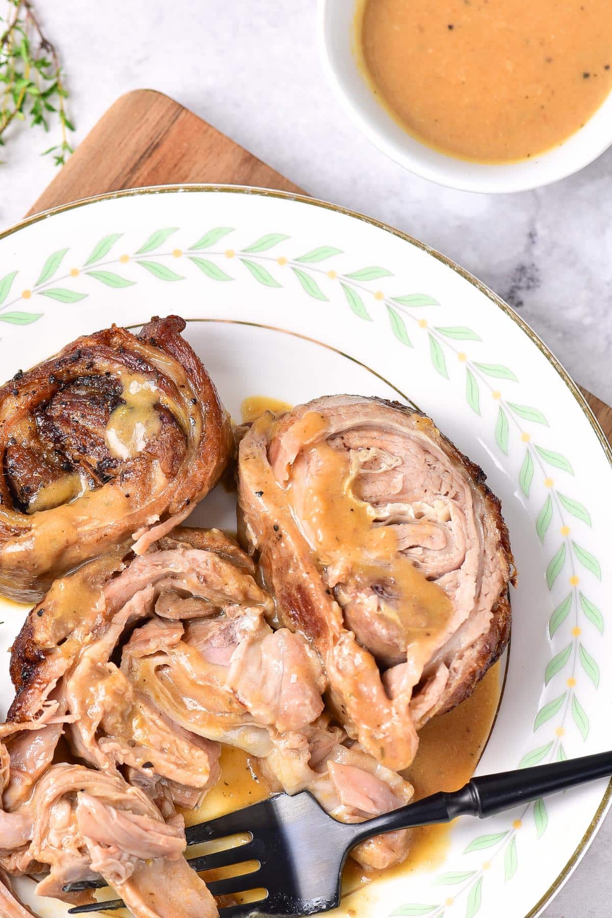 Up close shot of sliced oven roasted lamb on plate.