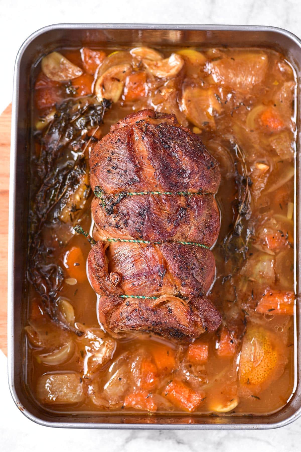 Roasted lamb breast in baking pan.