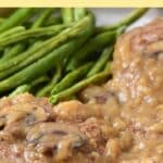 Salisbury steak and green beans on plate.