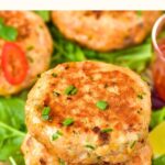 A stack of salmon thai fish cakes on parchment paper.