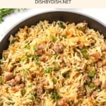 A skillet with sausage dirty rice.