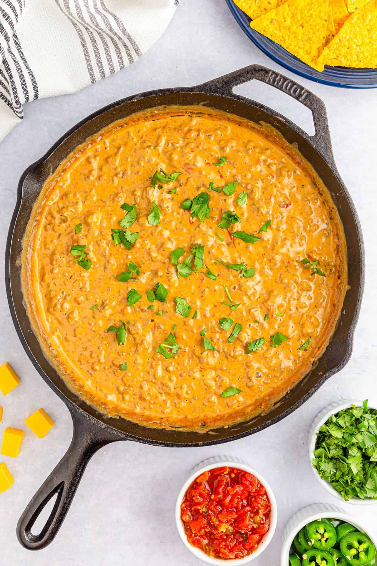 A cast iron skillet with cheesy rotel dip.