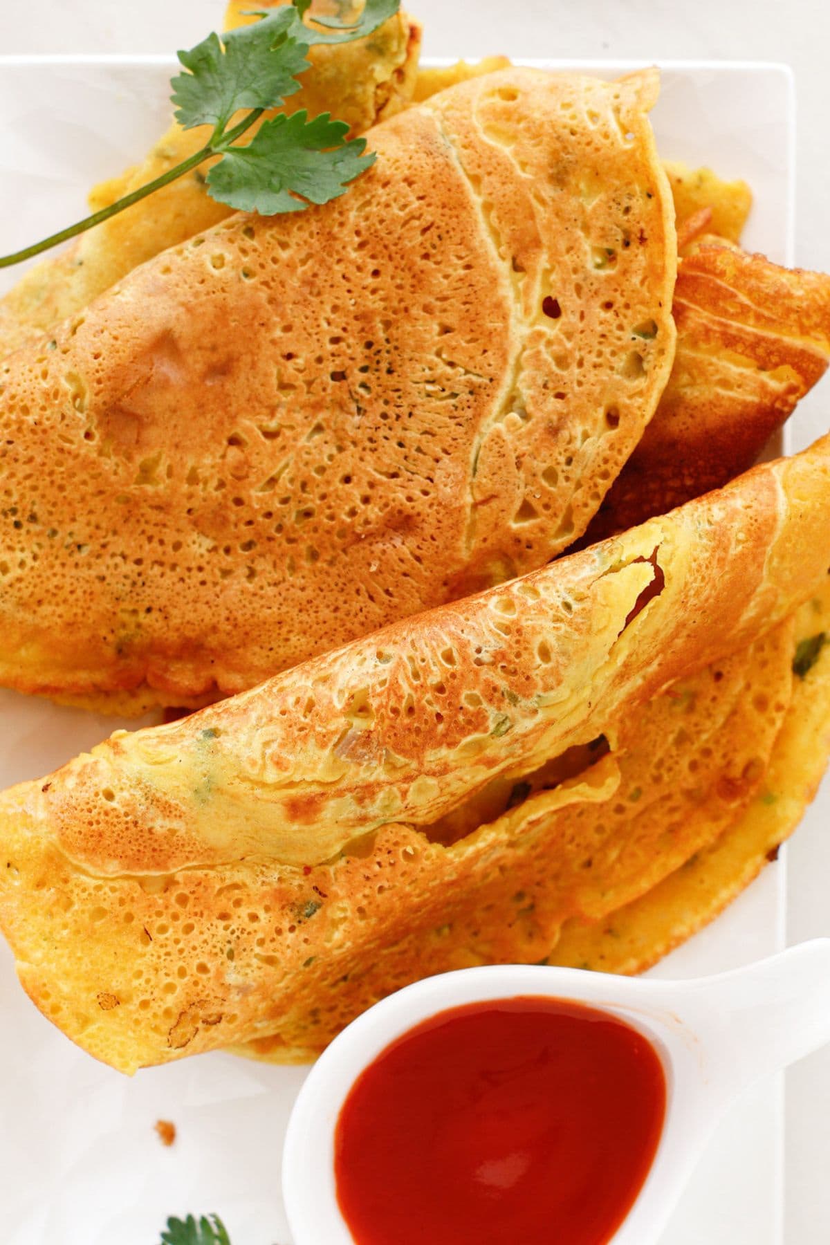 Up close view of chickpea flour crepes on plate