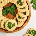 A wooden plate with savory parmesan cookies