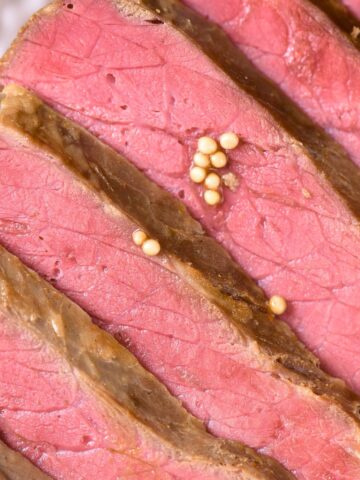 Slices of corned beef on white plate