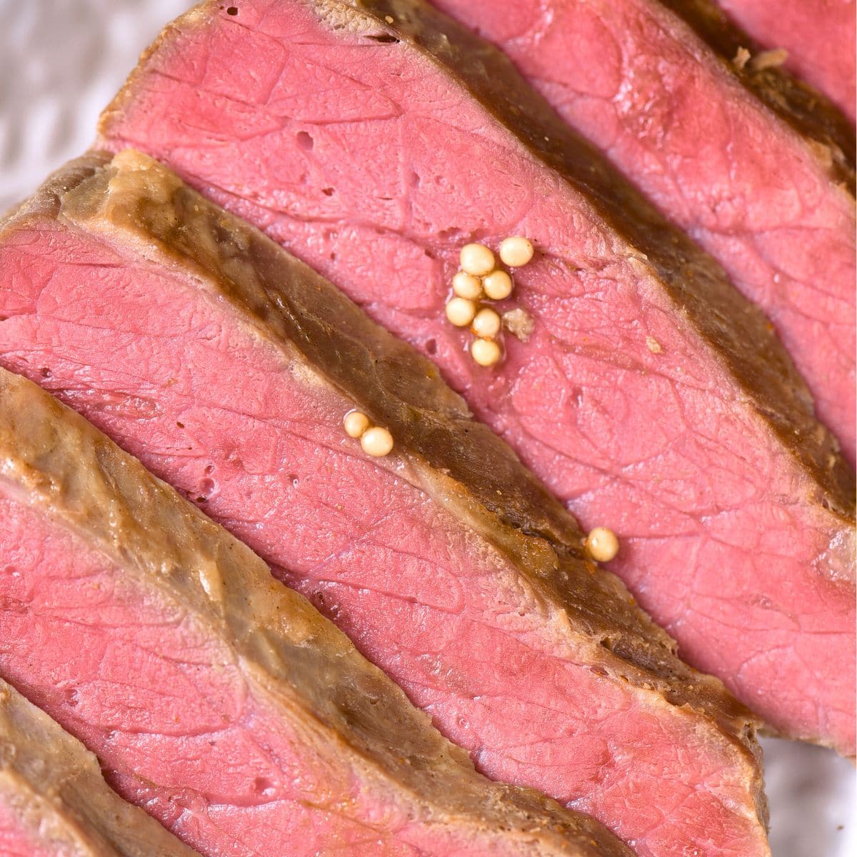 Slices of corned beef on white plate