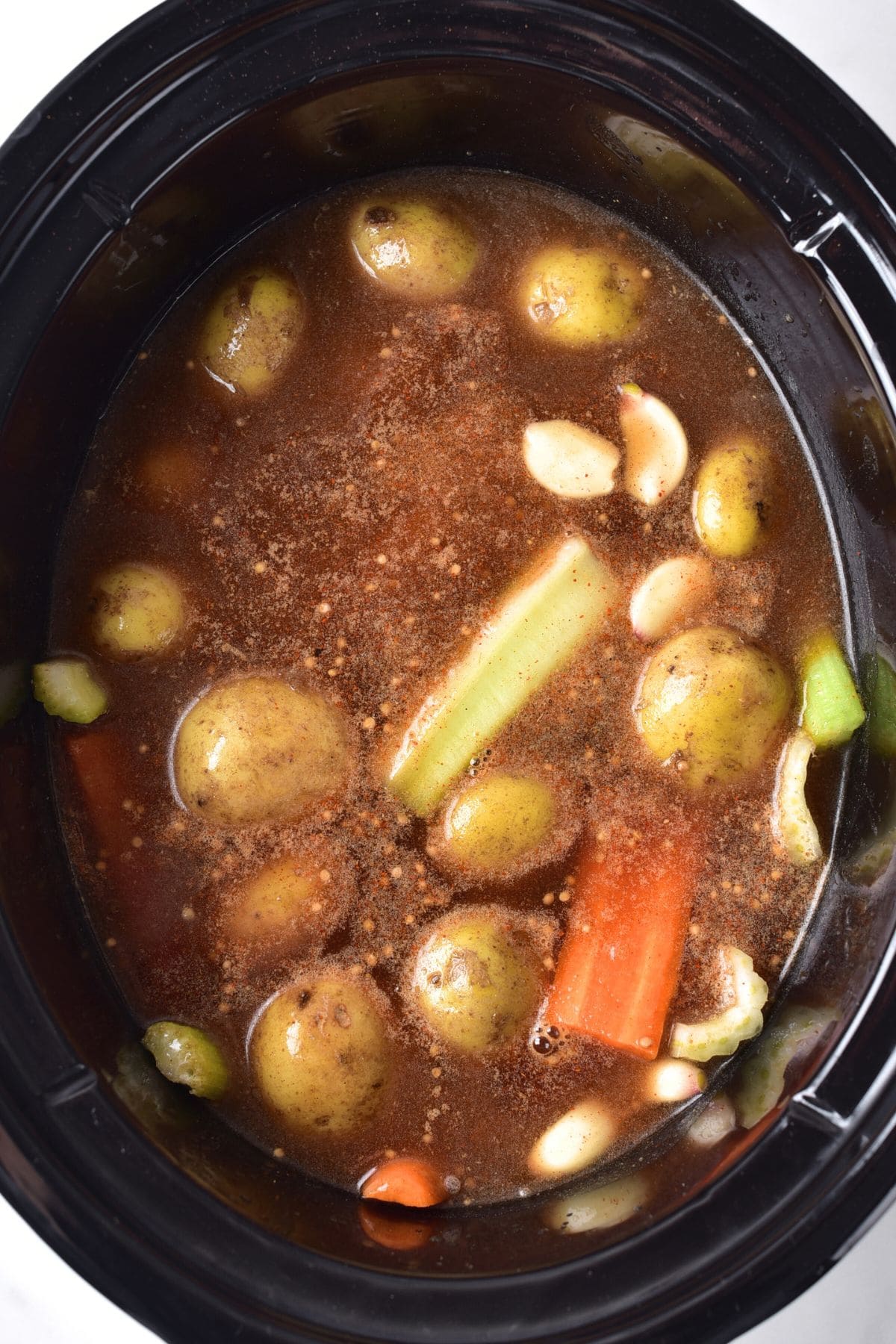Vegetables and broth in slow cooker