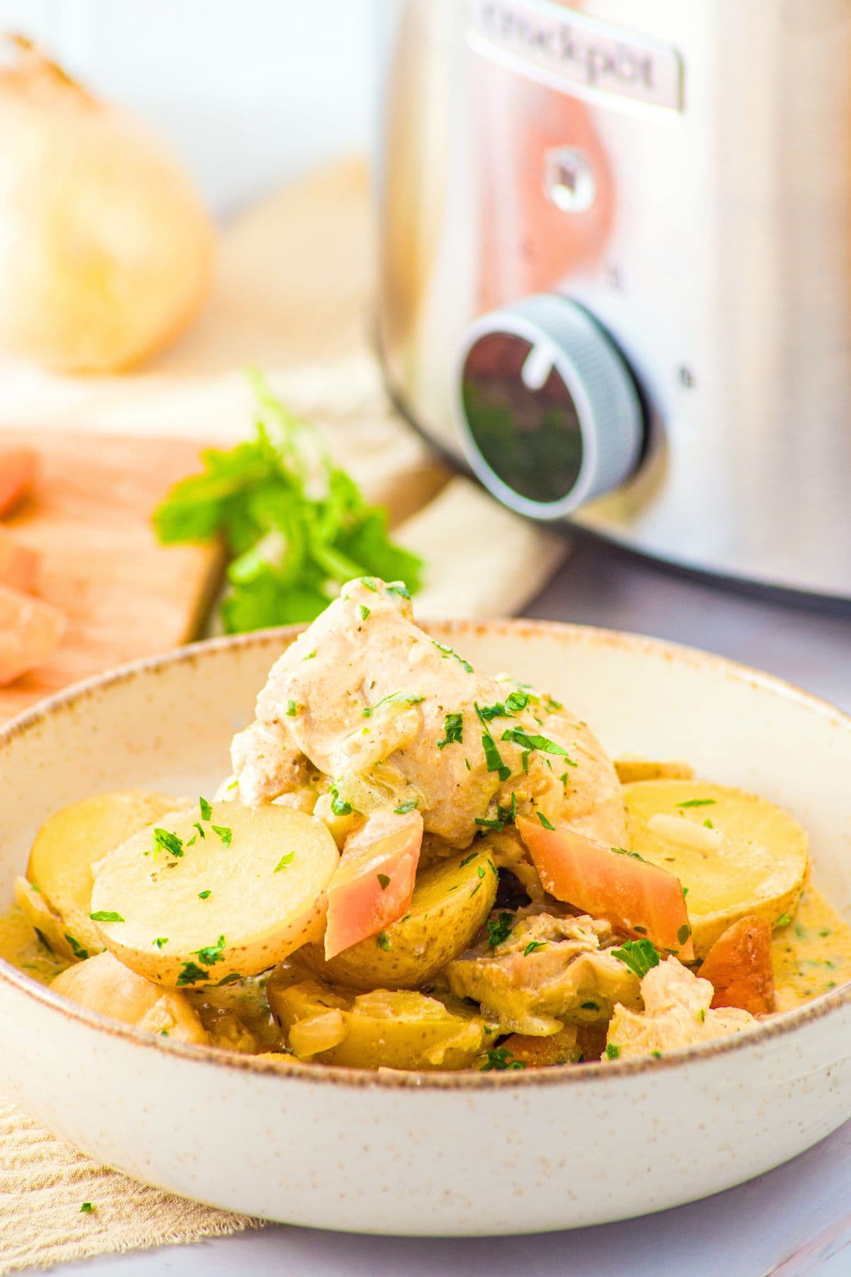 Ingredients for slow cooker chicken and potatoes recipe laid out on marble board.