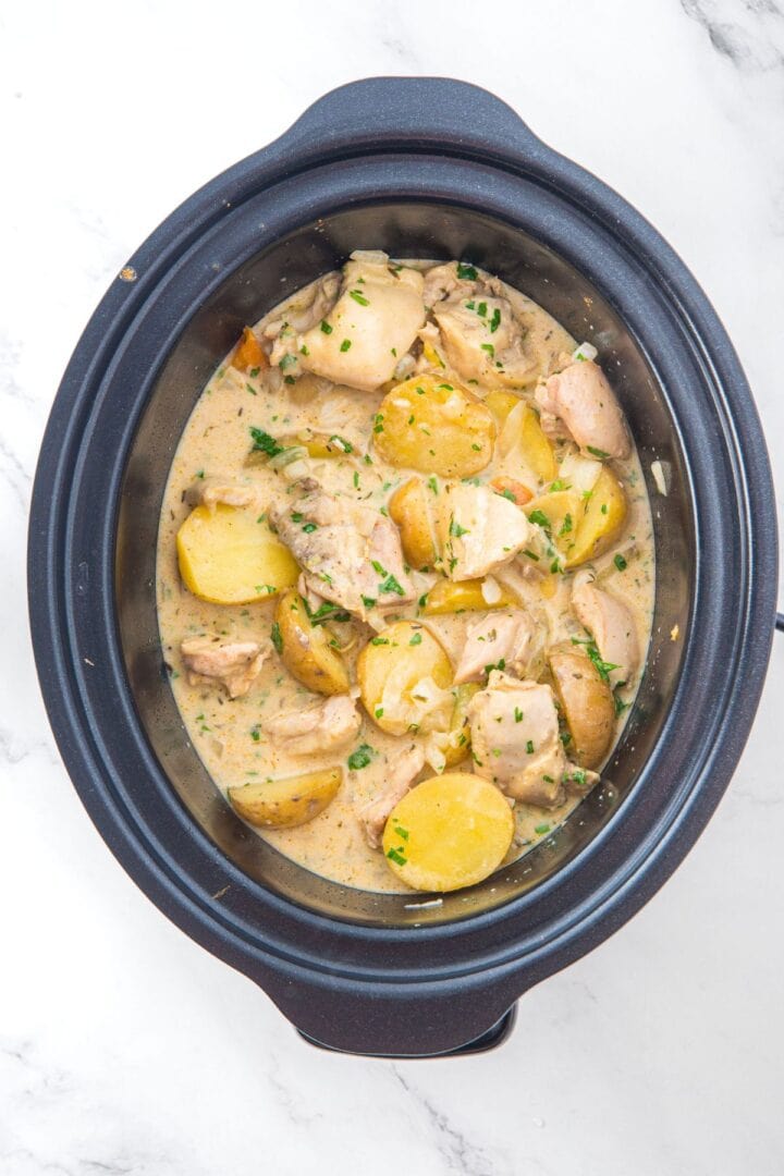 Top down view of crockpot creamy chicken and potatoes