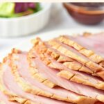 Up close view of sliced ham and fresh rosemary