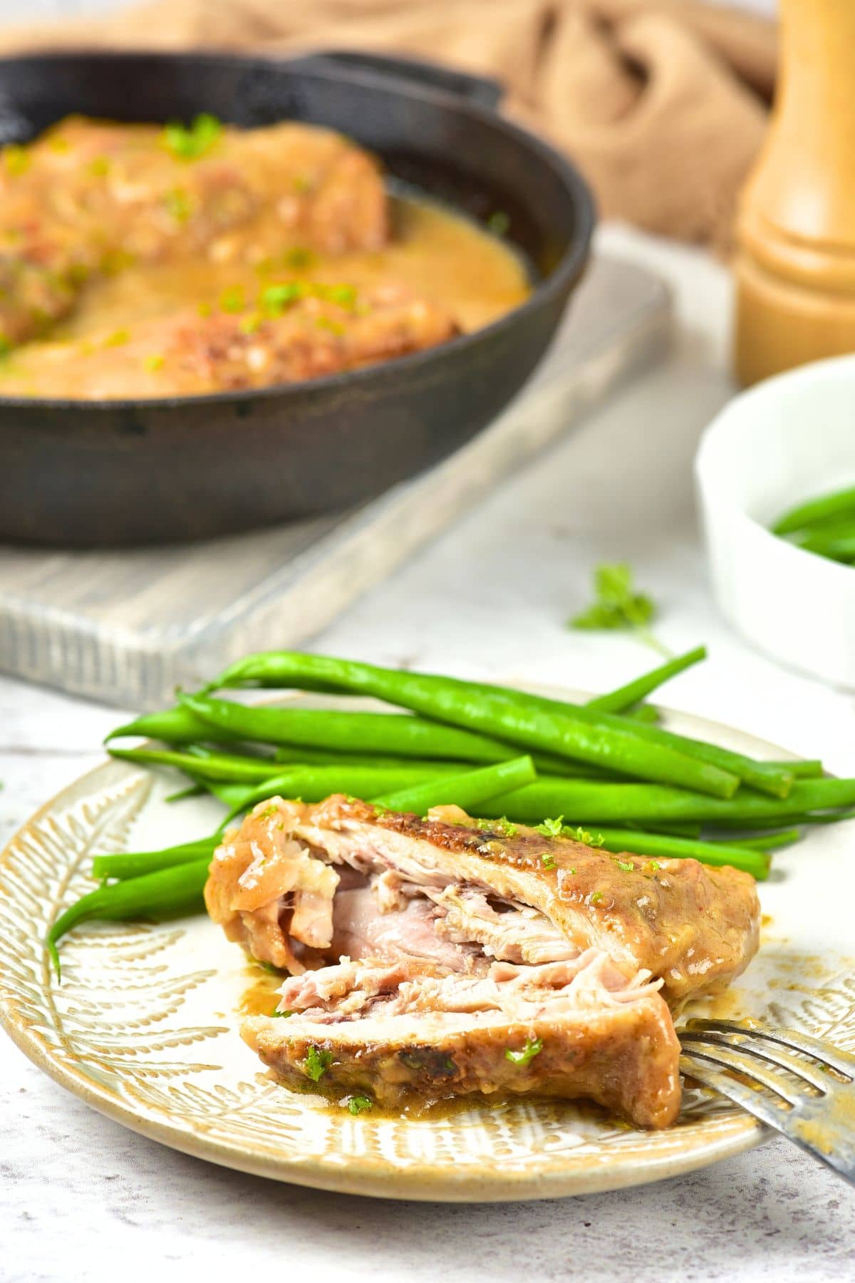 Gluten-Free Smothered Chicken Thighs (Dairy-Free) A plate with gluten-free smothered chicken thighs and green beans