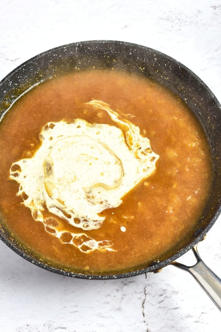 Dairy-free cream poured over chicken broth