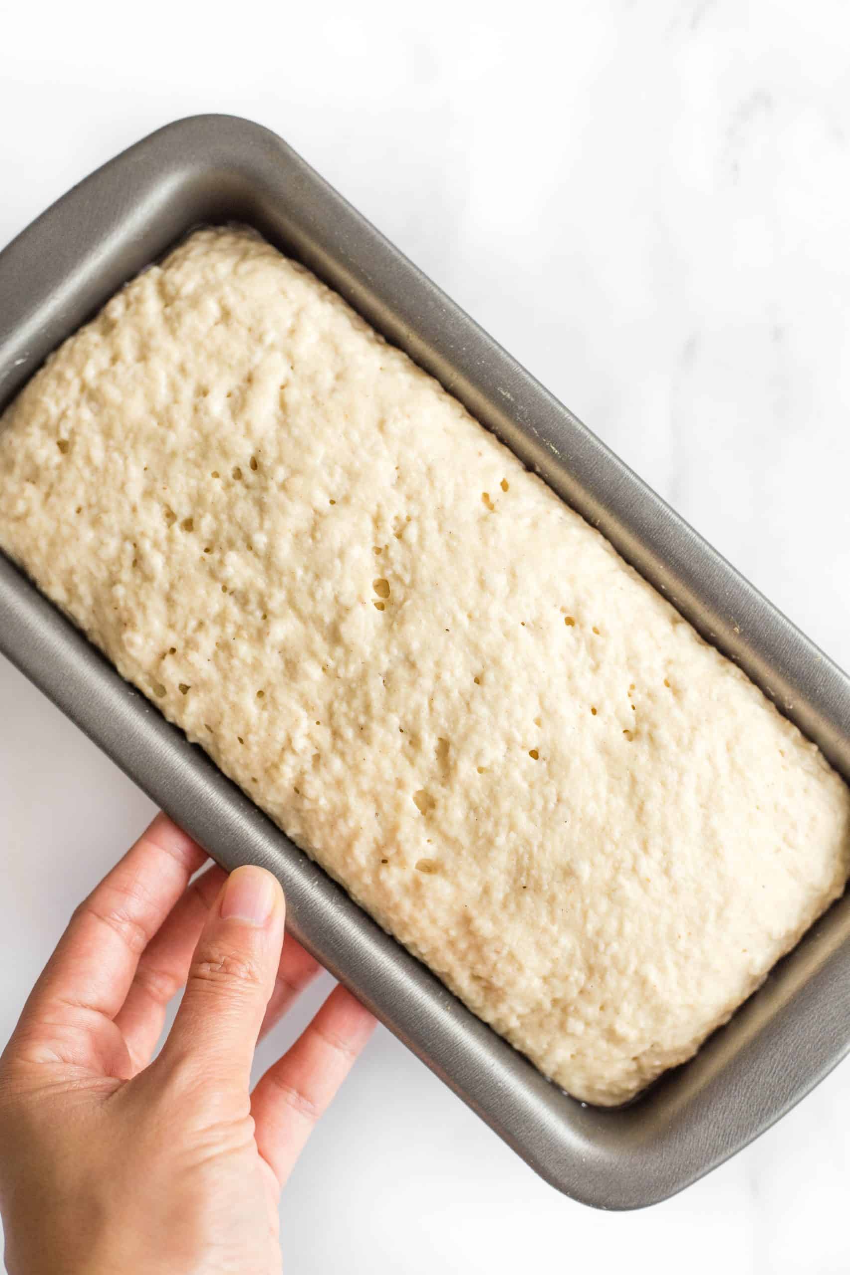 Holding a pan with risen bread dough