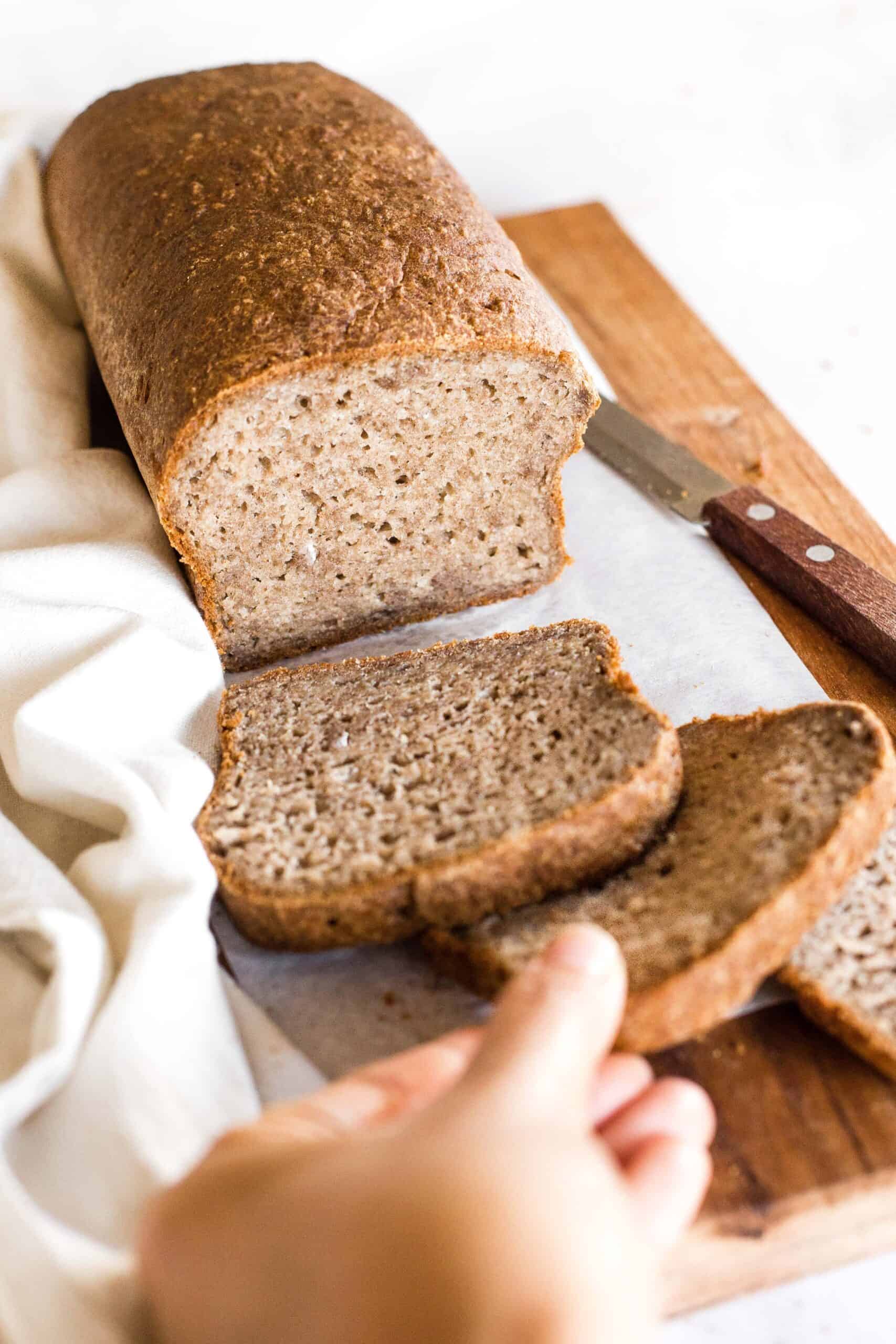 Reaching for a slice of teff bread.