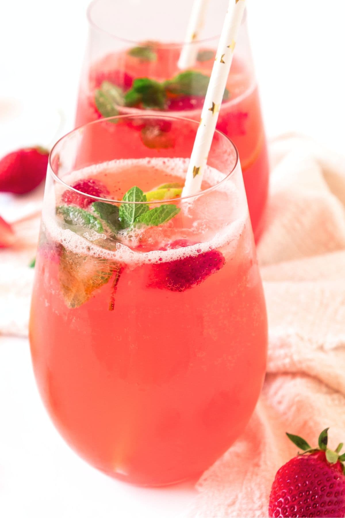 Two glasses of homemade strawberry lemonade.