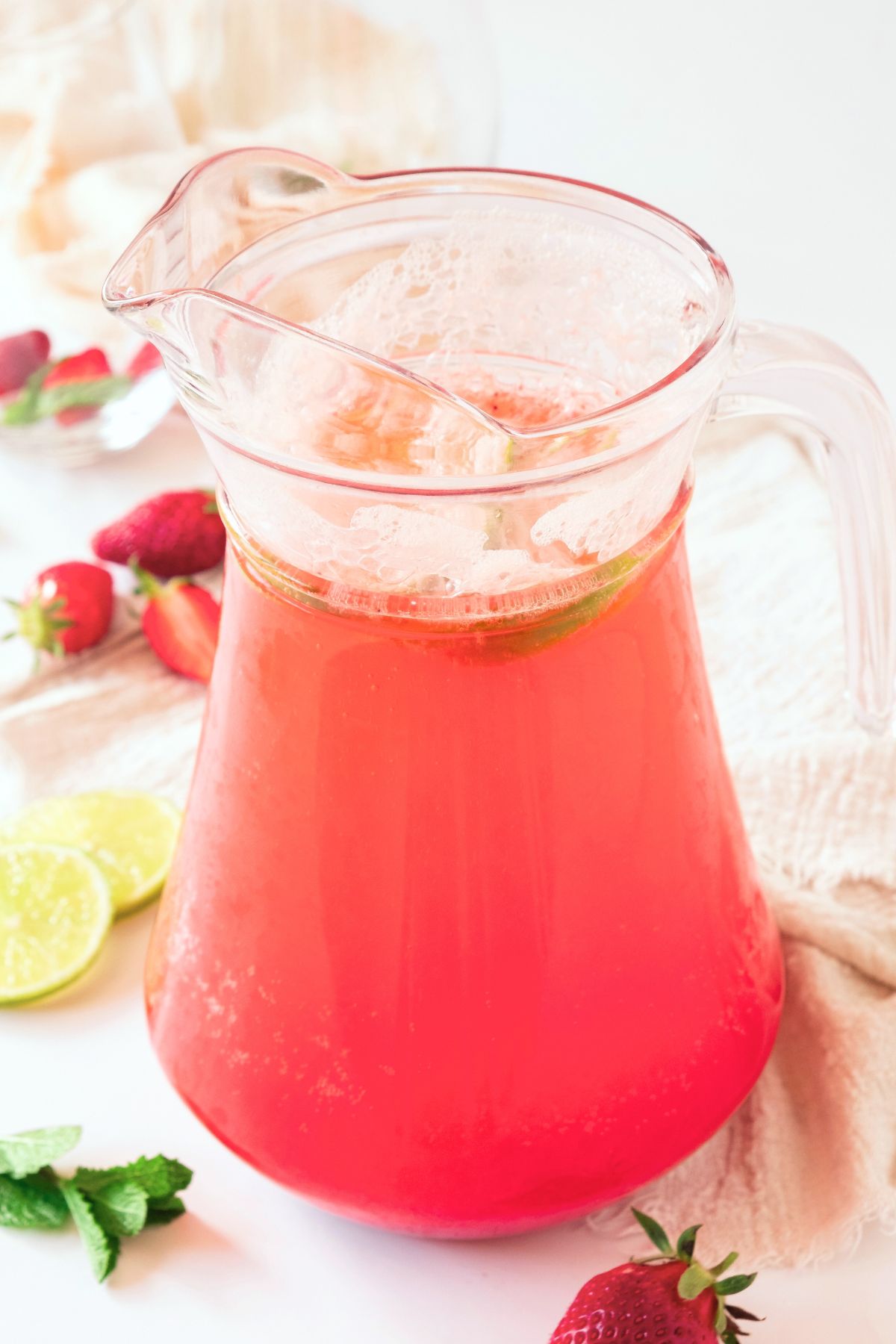 A pitcher of strawberry sparkling lemonade.
