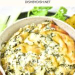 Up close view of a bowl of spinach artichoke dip