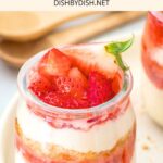 Cheesecake cups topped with fresh strawberries.