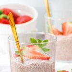 Glasses of strawberry chia seed pudding topped with fresh strawberries
