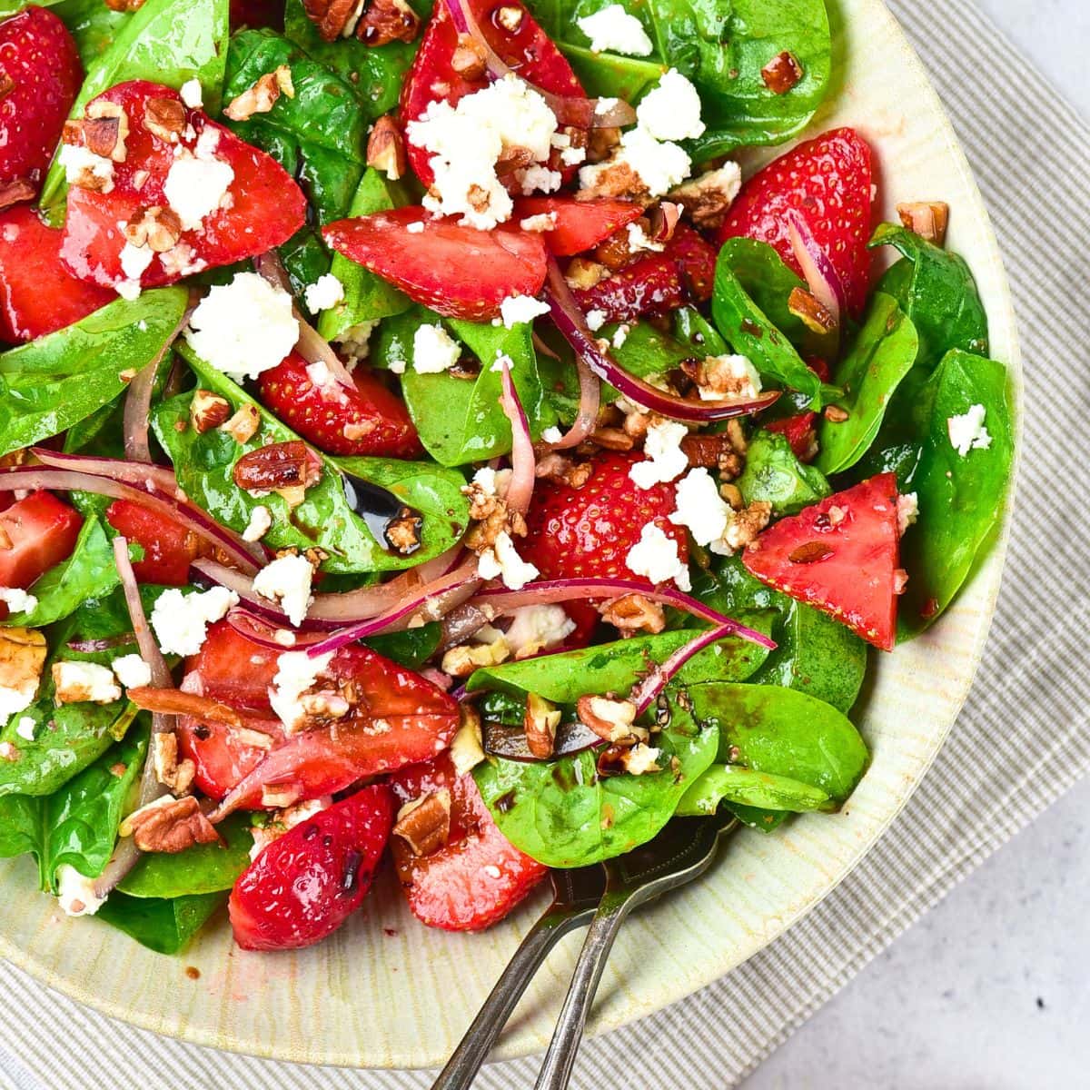 A bowl of strawberry spinach feta salad