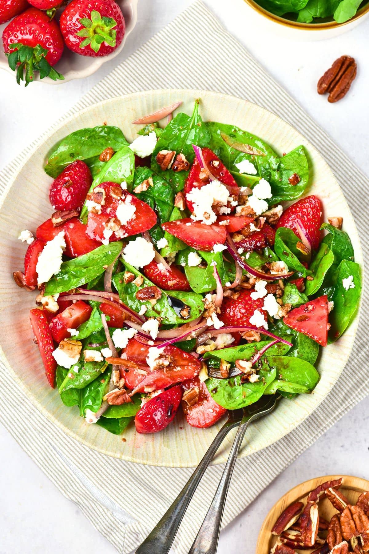 Top down view of a bowl of spinach strawberry feta salad