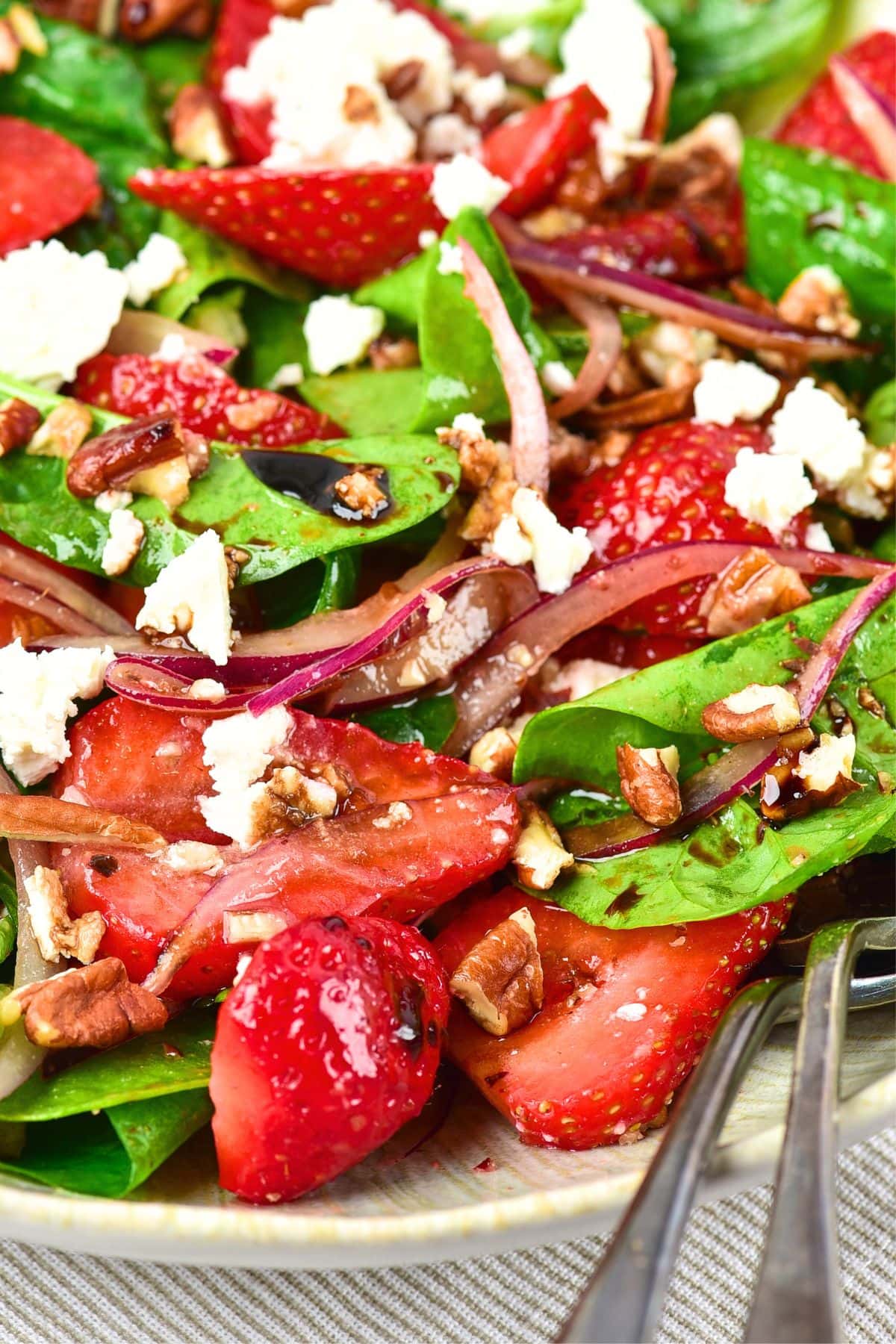 Up close view of spinach and strawberry feta salad