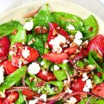 Top down view of a bowl of strawberry spinach feta salad