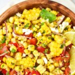 Top down view of a bowl of grilled corn salad.