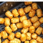 Tater tots in an air fryer basket.
