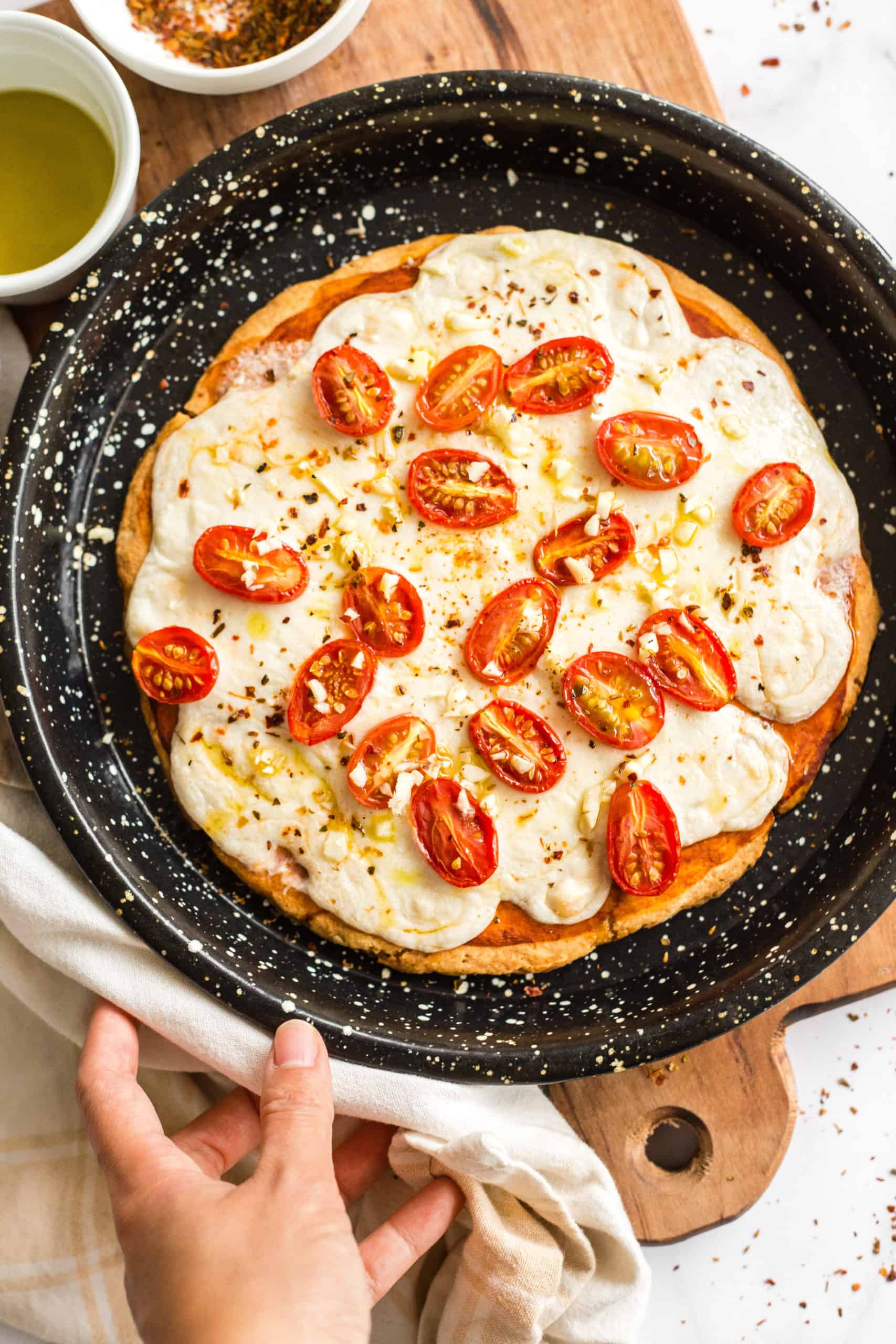 Gluten-free pizza in a pizza pan.