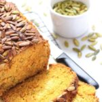 Sliced loaf of moist pumpkin bread on wire rack