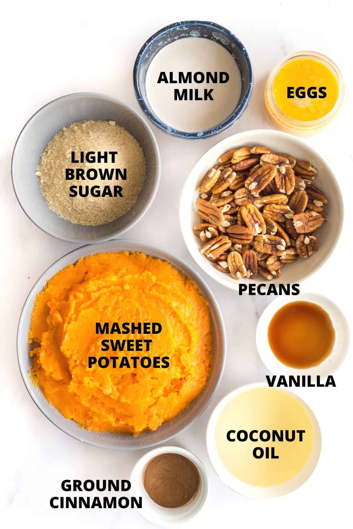 Labeled ingredients for gluten-free sweet potato casserole on a marble board.
