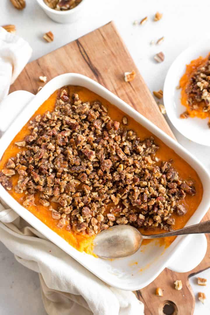 Top down view of sweet potato casserole on top of wooden board.