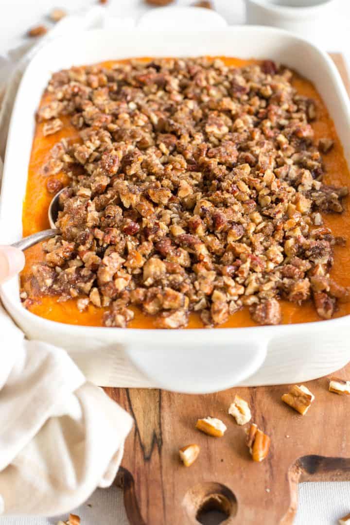 Gluten-free dairy-free sweet potato casserole on wooden board.