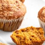 Half-eaten sweet potato muffins on plate.
