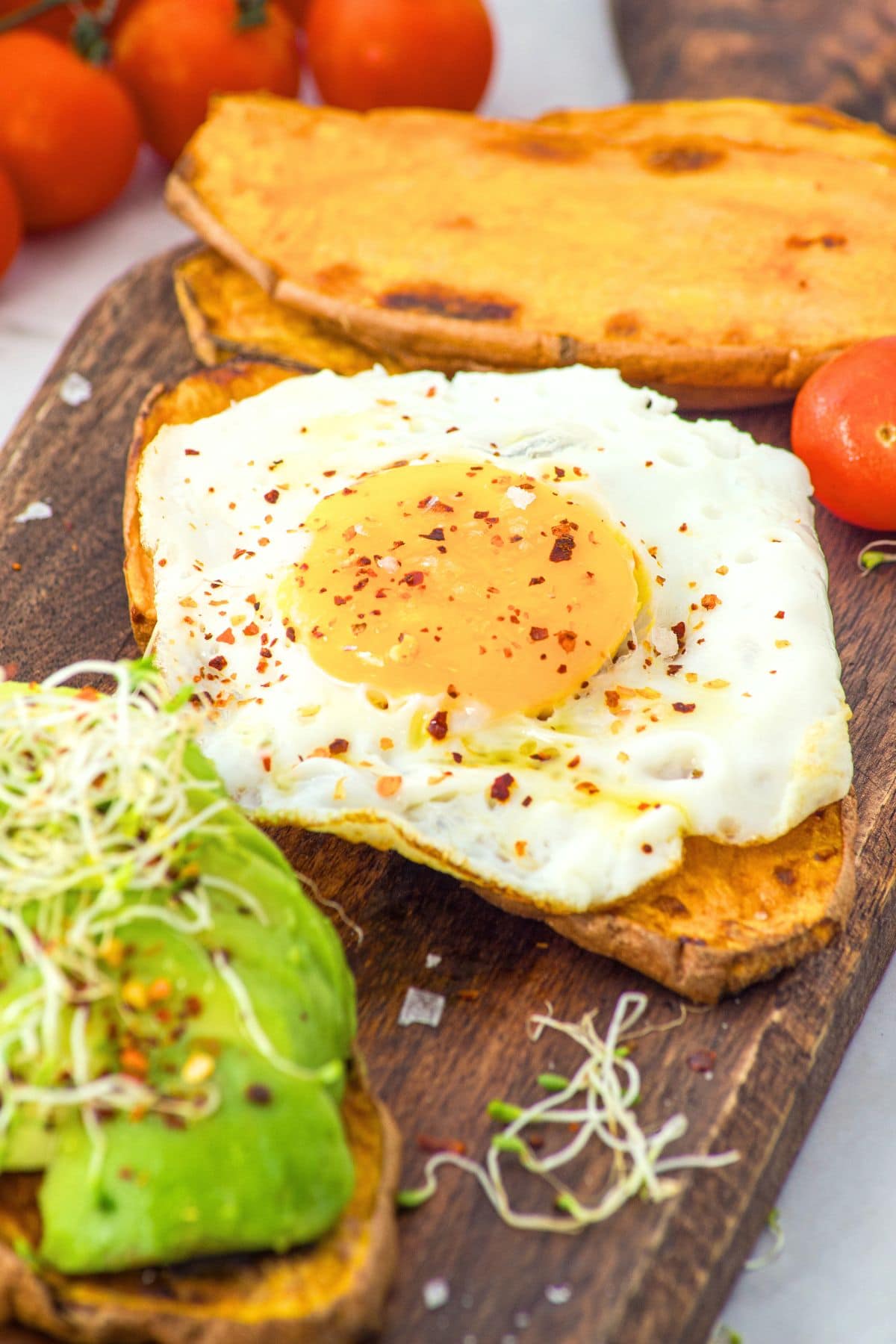 Up close shot of sweet potato toast topped with fried egg