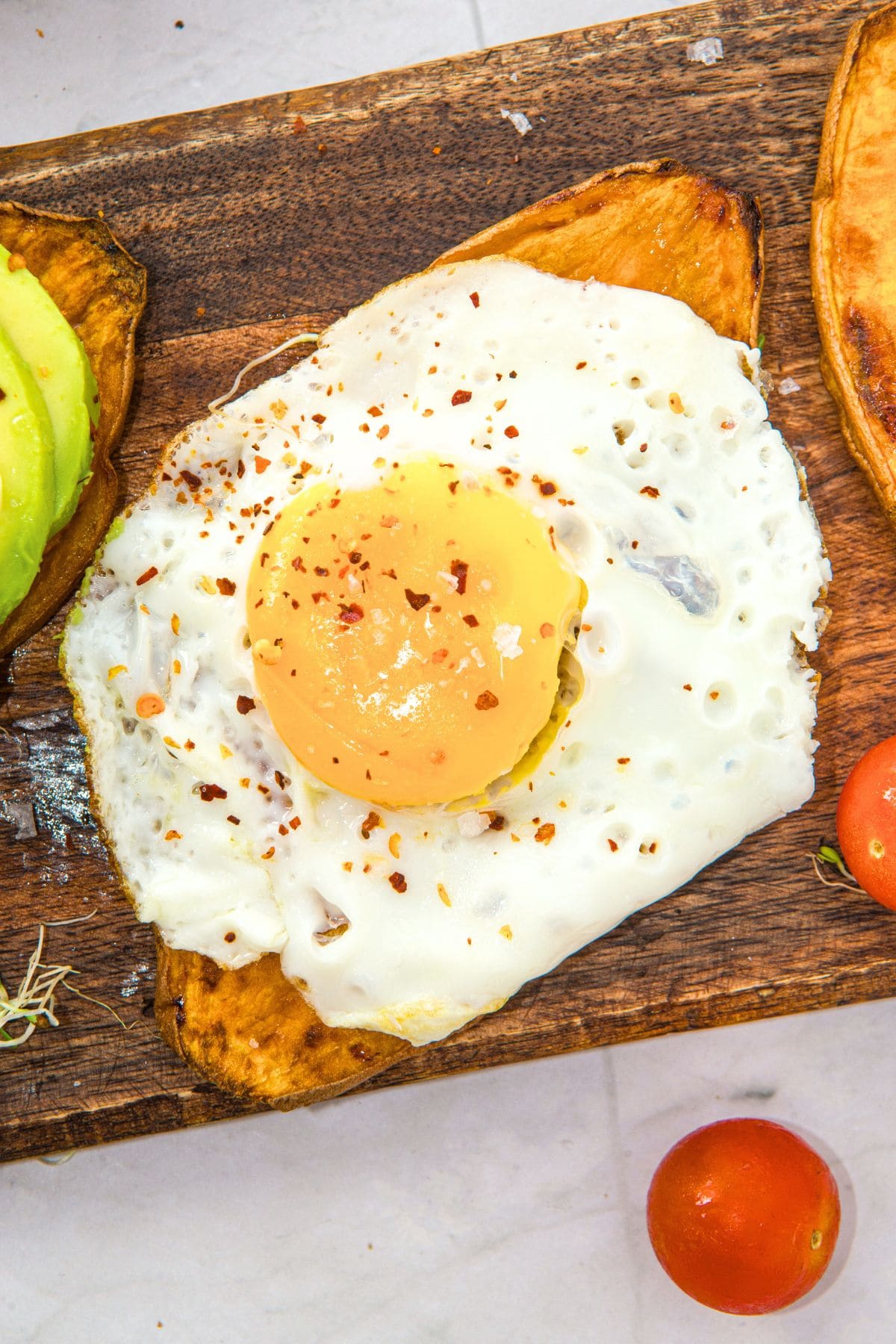 Fried egg on top of toasted sweet potato slice