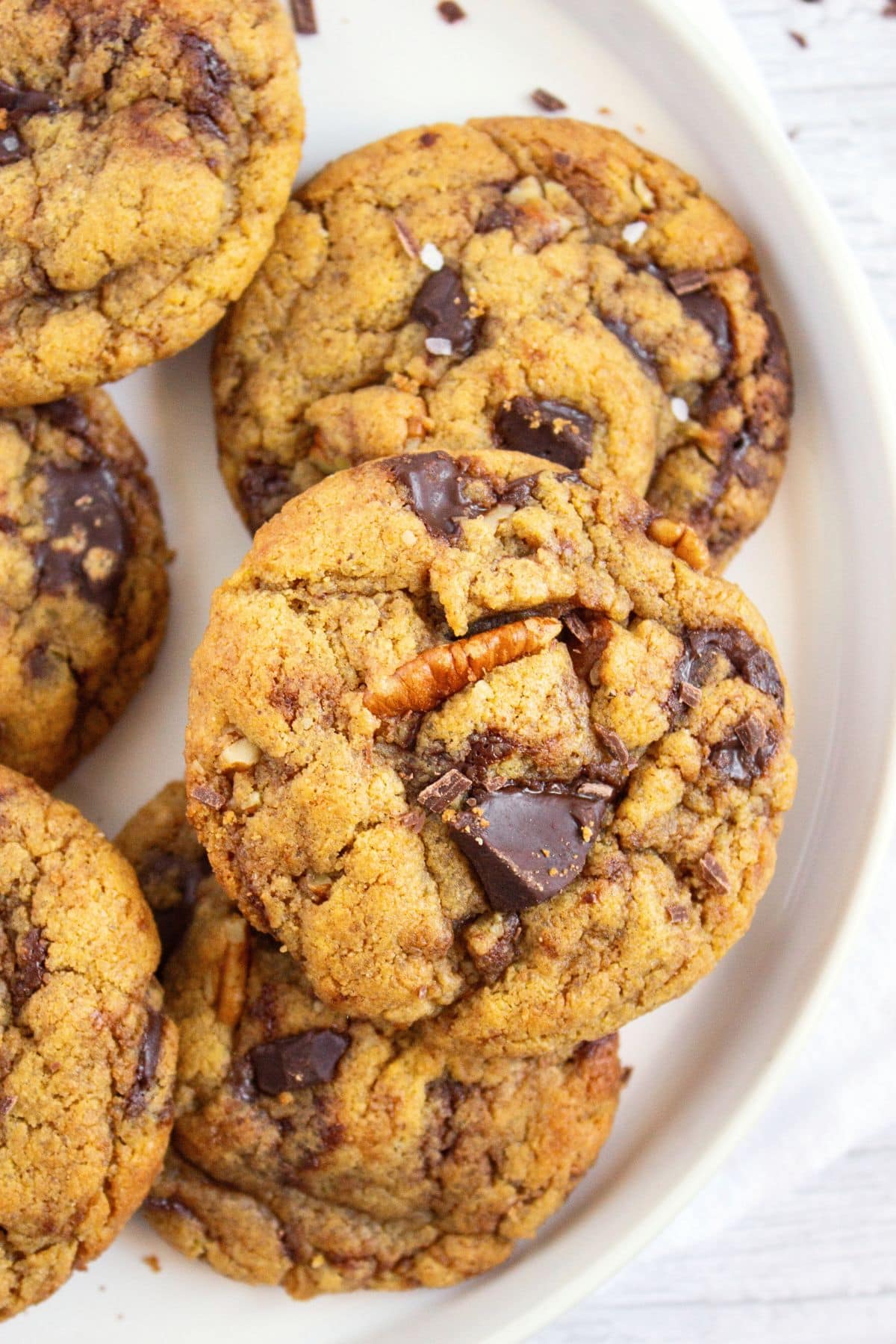 Top down view of a plate of chocolate chip tahini cookies